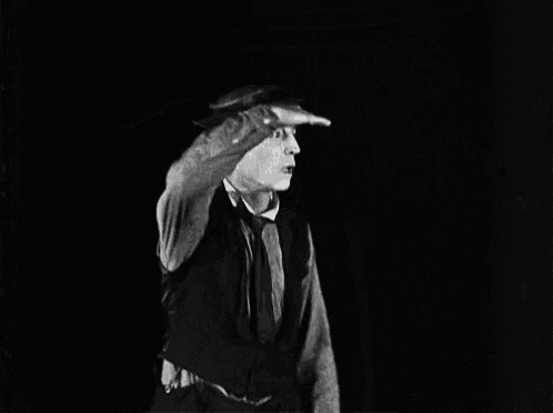 a man salutes with his hand on his forehead