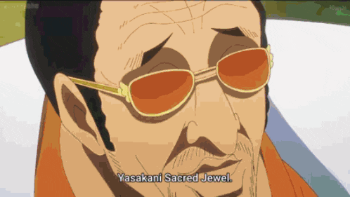 a man wearing sunglasses with the words yasakani sacred jewel below him