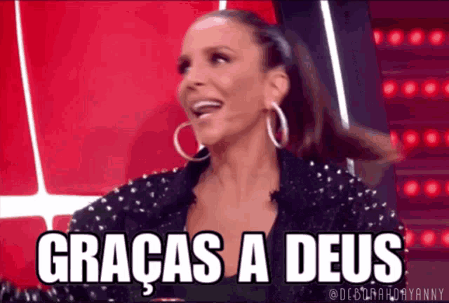 a woman wearing hoop earrings is smiling and says graças a deus