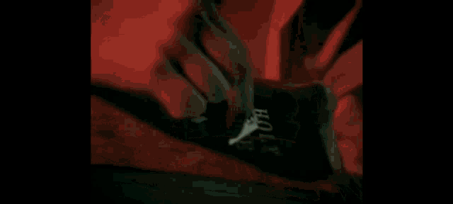 a man with blood coming out of his chest is screaming in the dark .