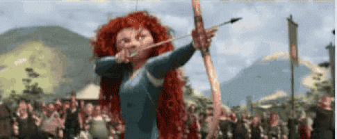 a woman is holding a bow and arrow in front of a crowd of people .