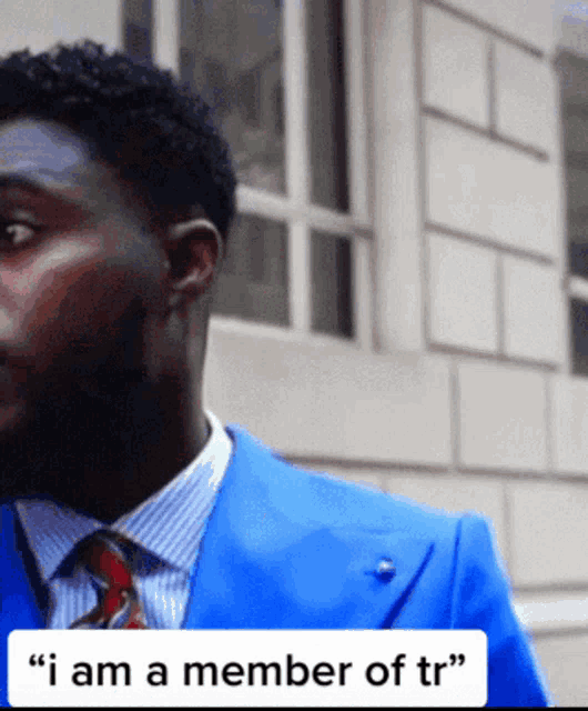 a man wearing a blue suit and tie says i am a member of tr
