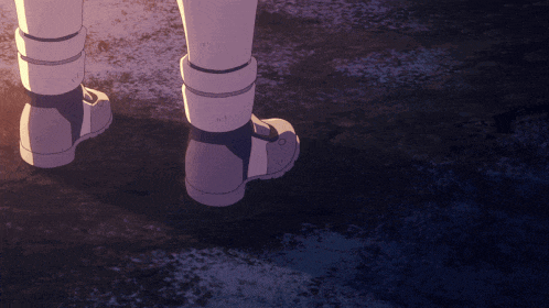 a close up of a person 's feet in a pair of white boots