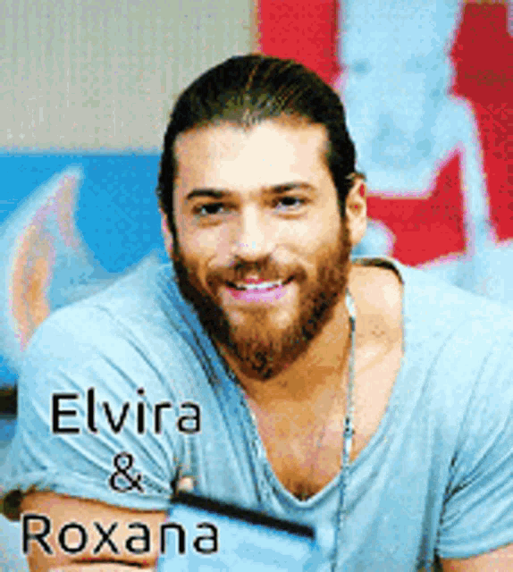 a man with a beard is wearing a blue shirt with the name elvira and roxana on it
