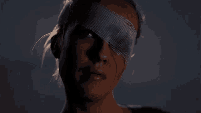 a woman with a bandage on her eye has blood coming out of it