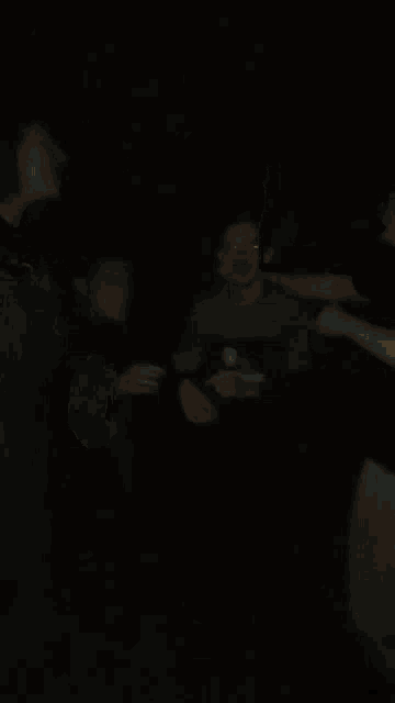 a blurry picture of a person 's face with a green jacket on