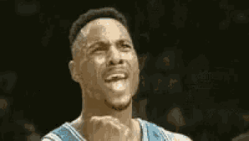 a close up of a basketball player making a funny face while playing basketball .