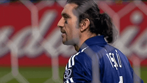 a man wearing a blue shirt with the number 1 on it
