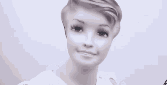 a close up of a person 's face with a blurred image of their face .