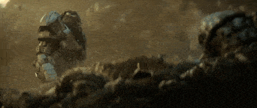 a man in a helmet is laying on the ground in the dirt .