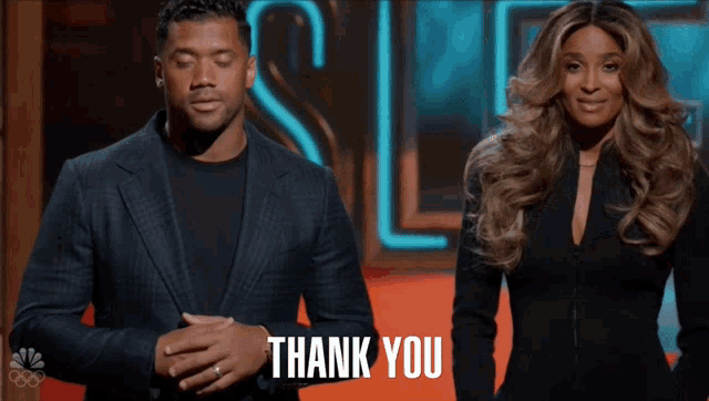 a man and a woman are standing next to each other and the words thank you are visible