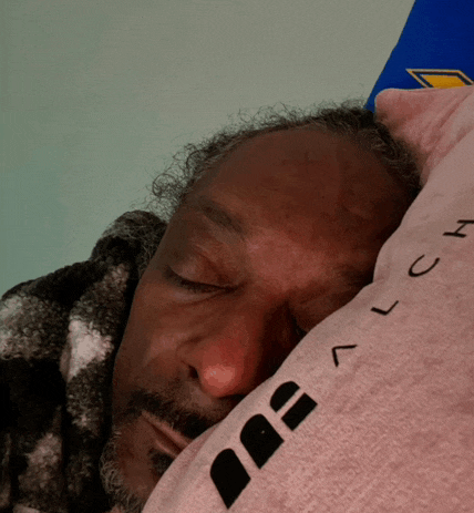 a man is sleeping on a pillow that says lch on it