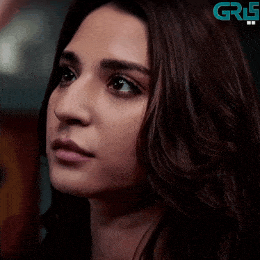 a close up of a woman 's face with a grf logo in the corner