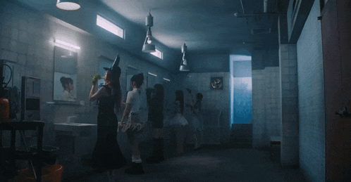 a group of people standing in a dark room