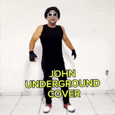 a man is standing in front of a wall with the words john underground cover