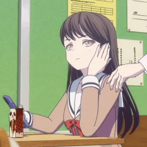 a girl sits at a desk with her hand on her face and a box of coca cola in front of her