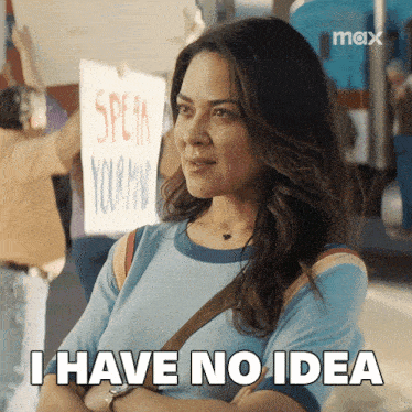 a woman says i have no idea in front of a protest sign