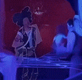 a man and a woman are standing next to each other in a dark room with blue lights .