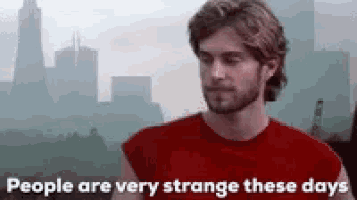 a man in a red shirt with the words people are very strange these days on the bottom