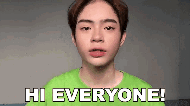 a young man in a green shirt says hi everyone !