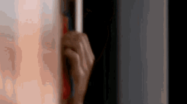 a close up of a person 's hand holding a pencil .