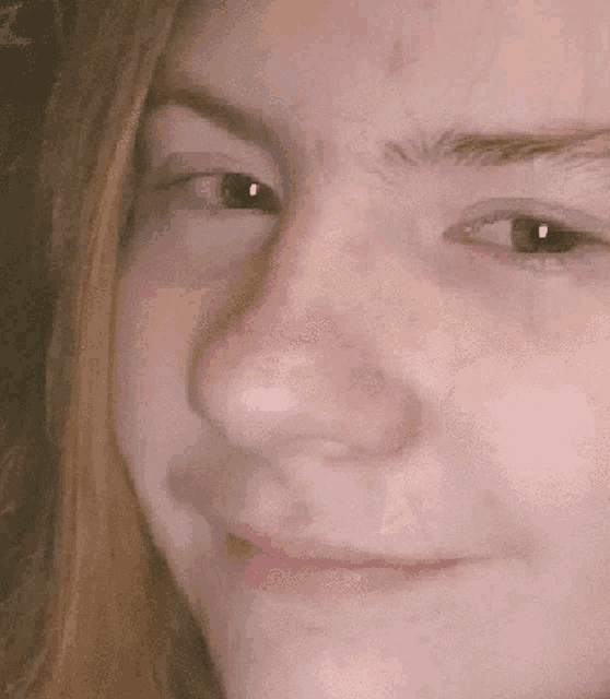 a close up of a person 's face with a smile on it .