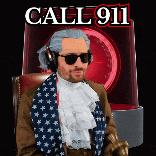 a man wearing a wig and sunglasses stands in front of a call 911 sign