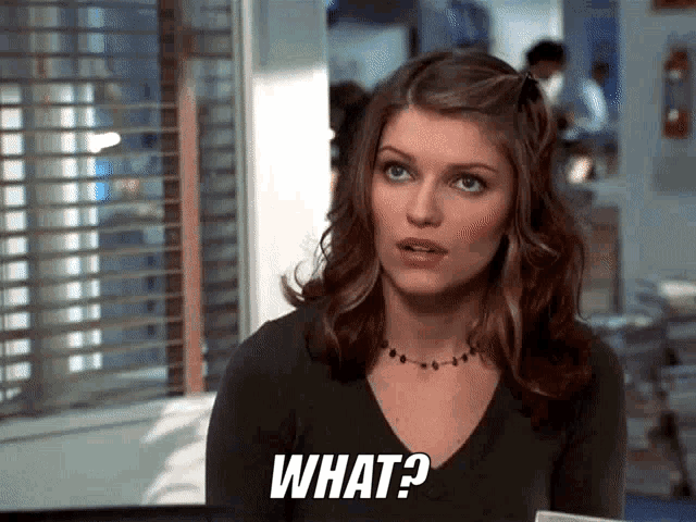 a woman with a necklace and a questioning look on her face says what