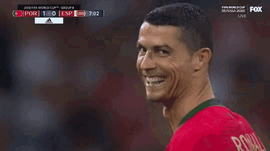a soccer player is smiling and looking at the camera during a soccer game .