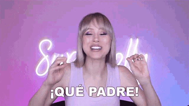 a woman in a purple tank top says que padre in spanish