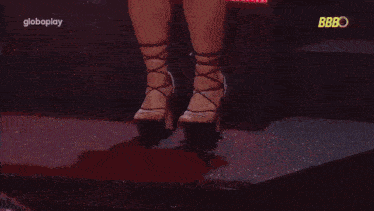 a woman 's legs are shown in a blurry photo with the word bbbo on the bottom