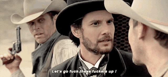 a man in a cowboy hat says " let 's go fuck those fuckers up "