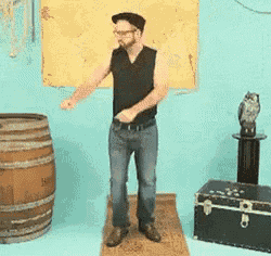 a man in a black tank top is dancing in front of a map