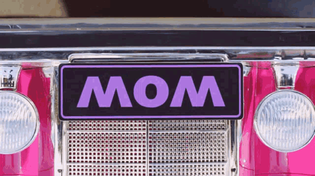 a pink car has a purple license plate that says mom
