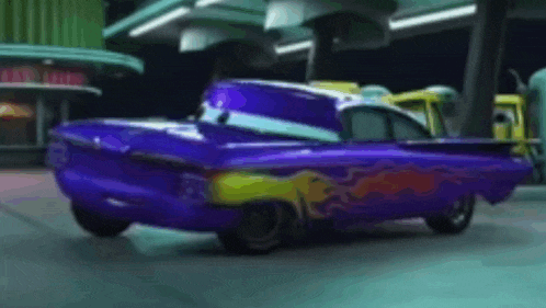 a purple car with flames painted on the side is parked in a parking lot .