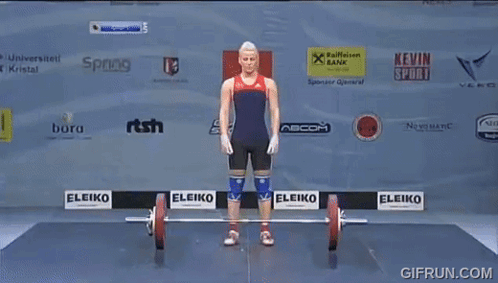 a woman is lifting a barbell in front of a wall with sponsor logos such as eleiko and kevin sport