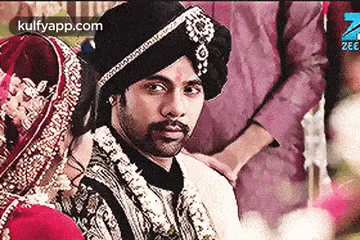a bride and groom are posing for a picture at their wedding .