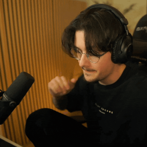 a man wearing headphones and a black shirt that says new york