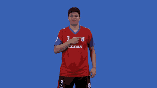 a young man wearing a red jersey with the number 3 on it
