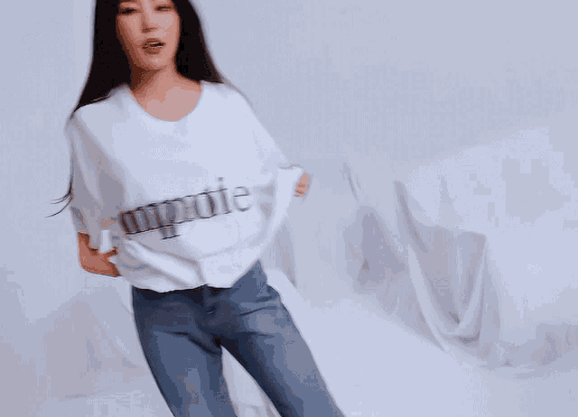 a woman is wearing a white t-shirt that says impeuter
