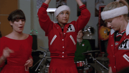 a cheerleader wearing a red jacket with the letter a on it