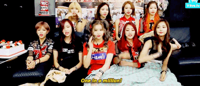 a group of girls are sitting on a couch and one of them says " one in a million "