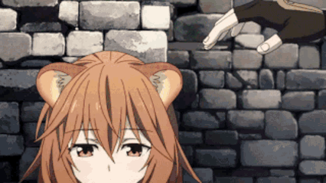 a girl with cat ears is standing in front of a brick wall ..