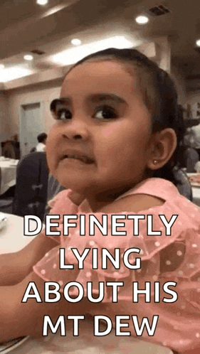 a little girl in a pink dress is sitting at a table with a caption that says " definitely lying about his mt dew