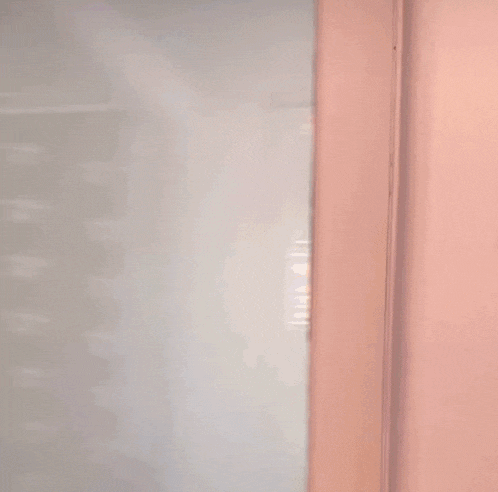 a blurry picture of a man peeking through a doorway