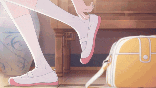 a girl is putting on a pair of pink and white shoes