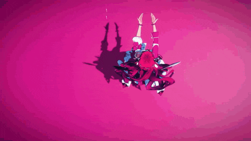 a woman in a red dress is laying on a pink surface