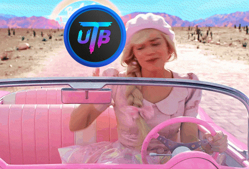 a woman in a pink dress is driving a pink car with a ub logo above her