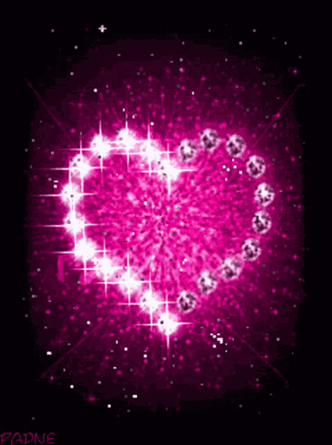a pink heart surrounded by diamonds on a dark background