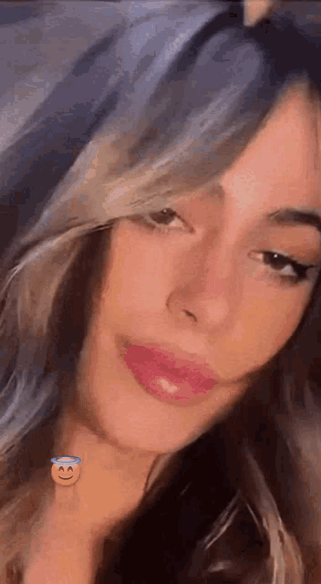 a close up of a woman 's face with a smiling face on her neck .